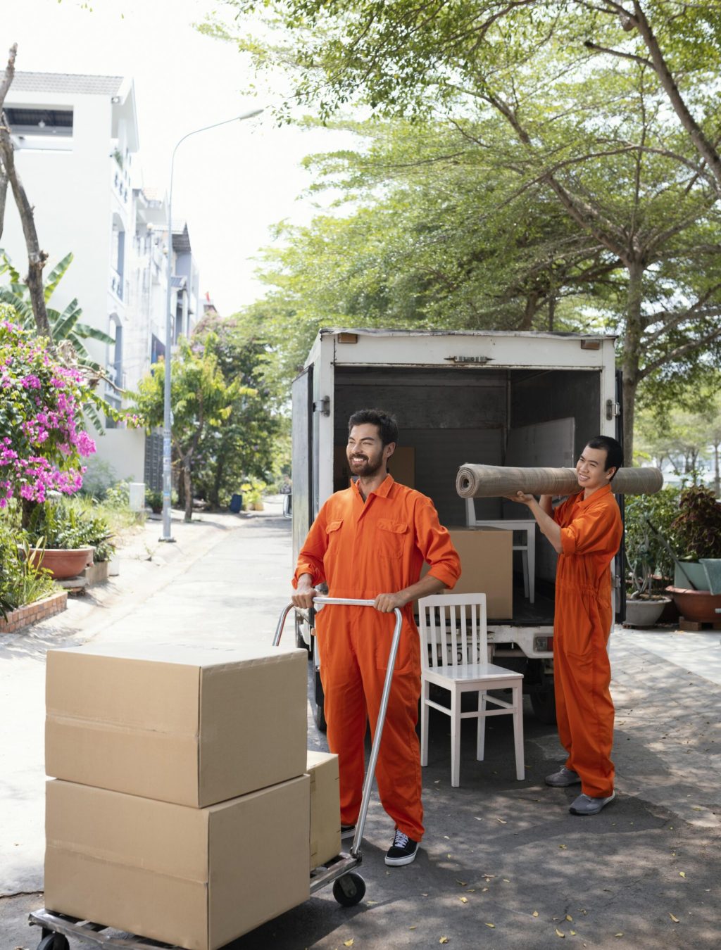 vertical-shot-young-delivery-men-moving-objects-out-car